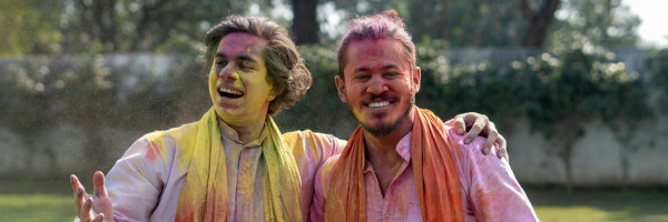 Happy couple playing with colourful powder