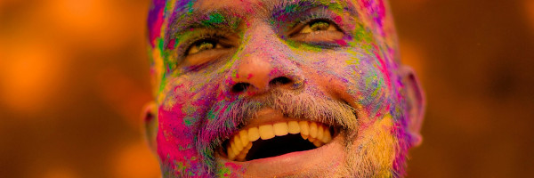 Smiling man with colourful face powder