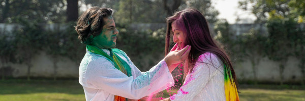 Happy couple playing with colourful powder
